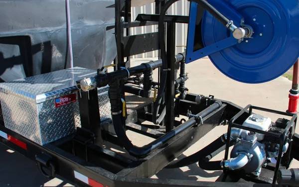 Side view of a water trailer equipped with a hose reel, pump system, and durable frame for efficient water transport.