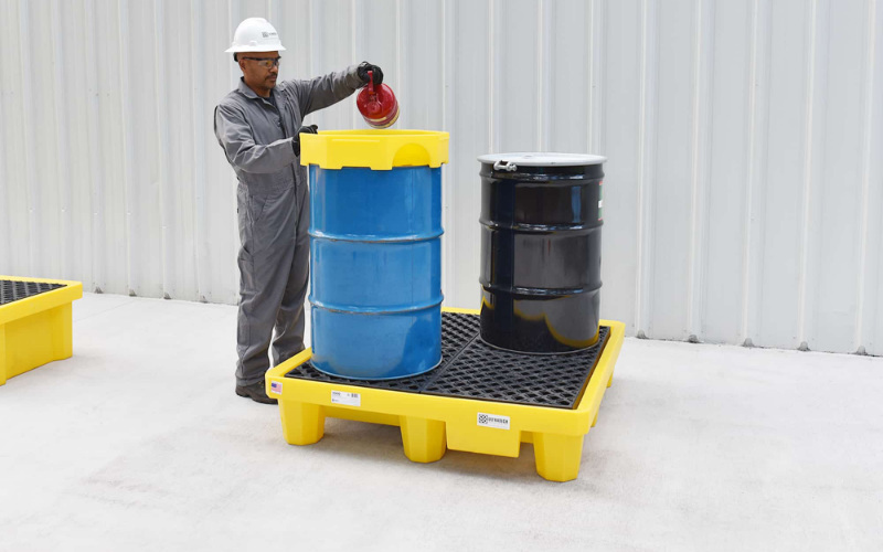 Spill pallets storing drums for leak containment