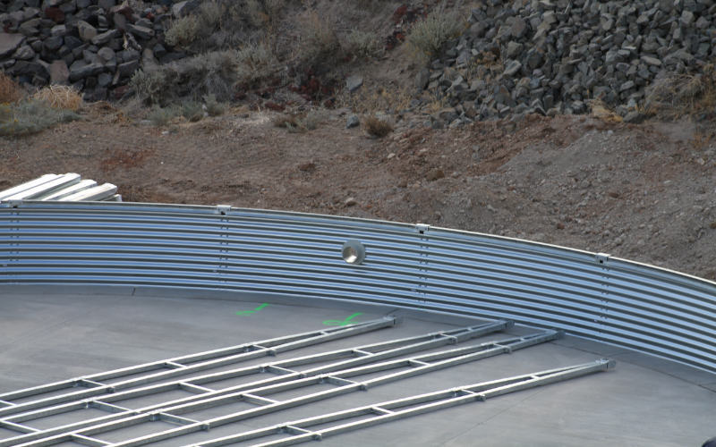 two corrugated steel water tanks sitting outside