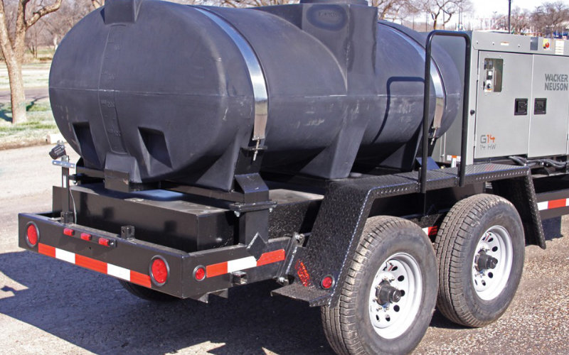 Black polyethylene water storage tank mounted on a trailer for mobile water or liquid transportation