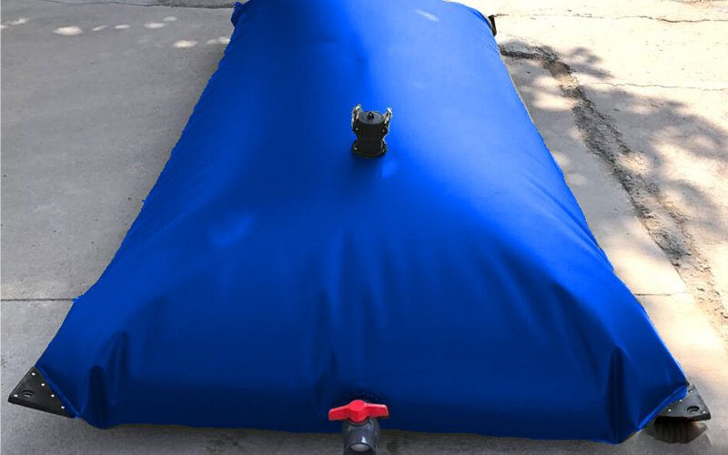 a close up of the top and side fitting of a blue flexible bladder tank