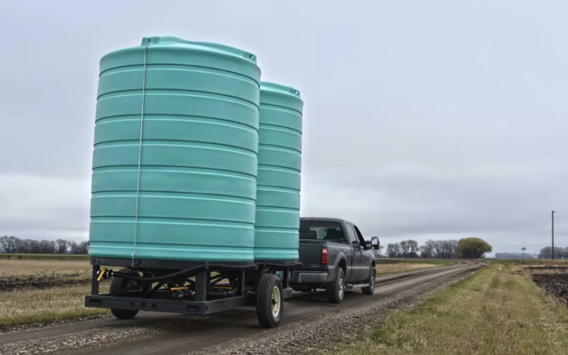 a double cone bottom trailer being towed by a truck