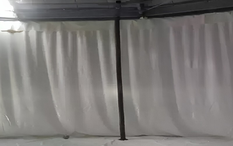 Interior view of a steel water tank with bolted liner, showing the detailed corrugated pattern and bolted connections inside the tank.