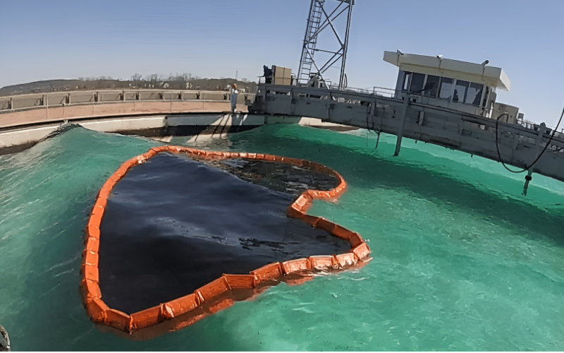 filter oil spill boom deployed on water to contain black oil