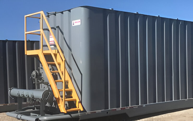 Blue hydraulic fracturing tanks with yellow ladders used for large-capacity fluid storage in industrial operations