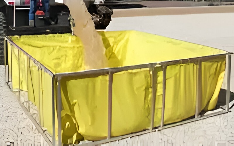 Yellow folding frame tank being filled with water, demonstrating its efficiency for construction, emergency relief, and industrial applications.