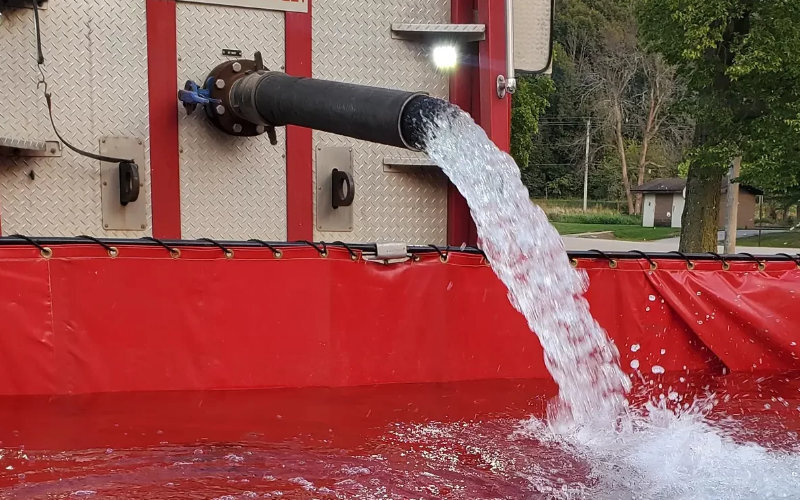 a red frame tank being filled with water