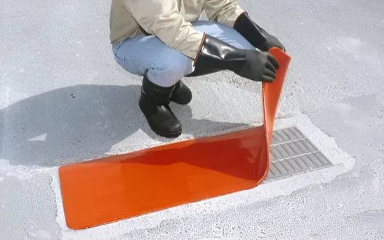 a man placed orange drain seal on the road