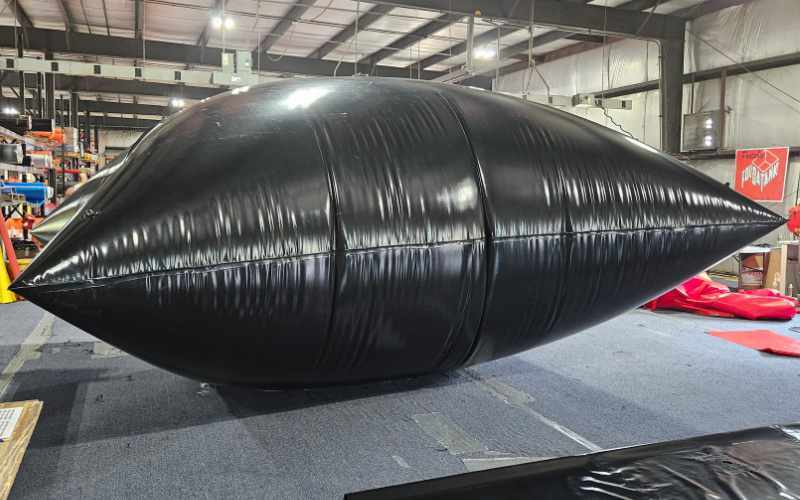 A large black bladder tank inflated for testing