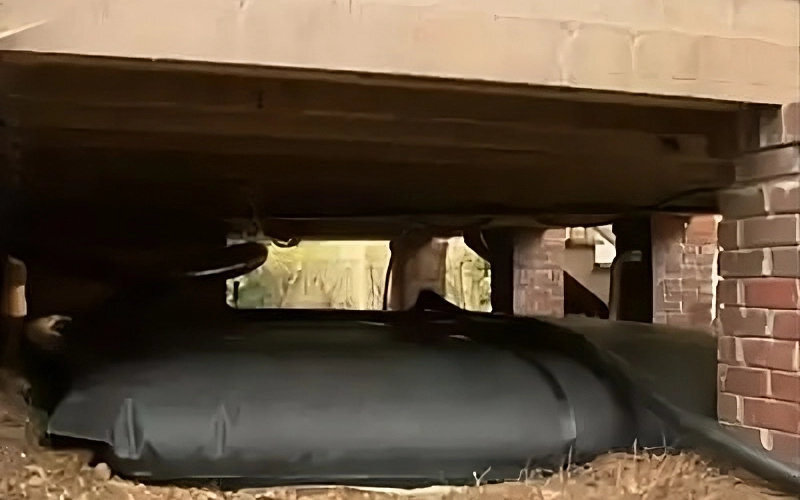 Flexible pillow tank placed under a crawl space for efficient liquid storage