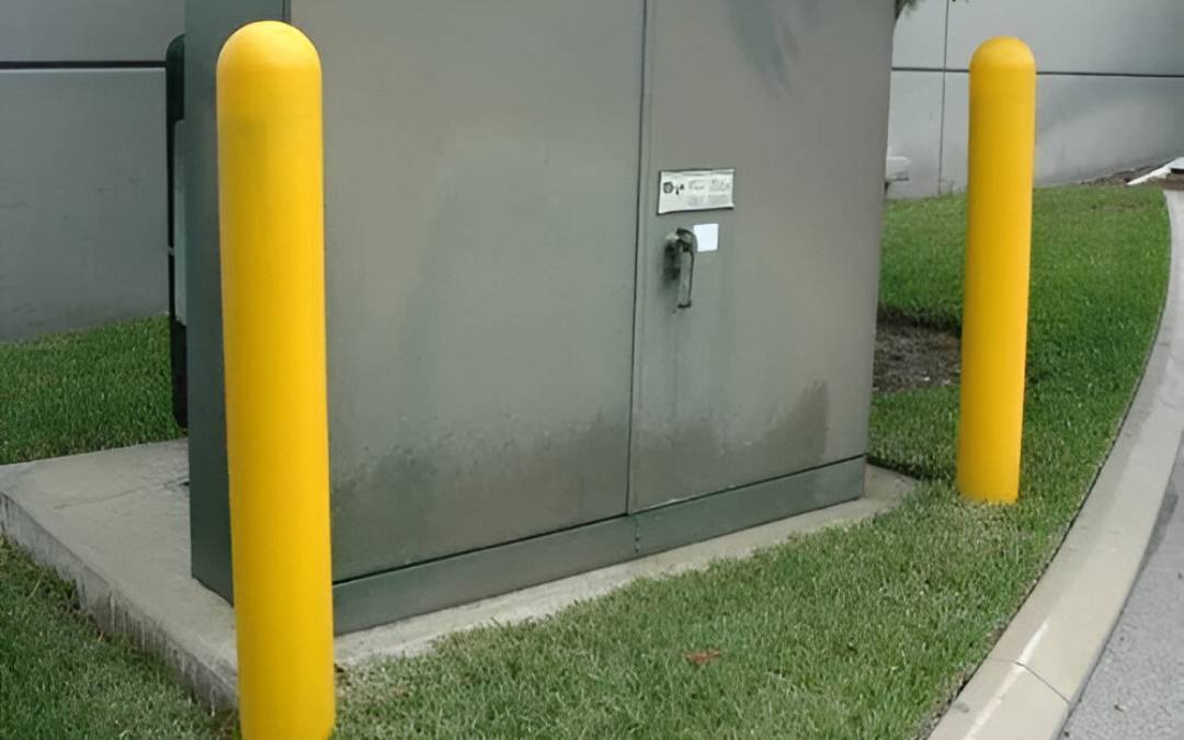 yellow protective guard on each side of the utility box