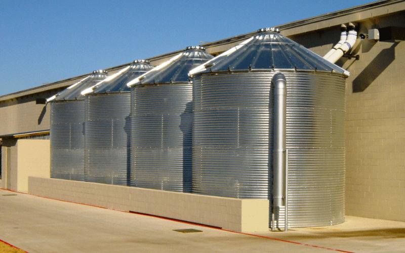 4 corrugated steel tanks with a 30 degree roof installed for rainwater collection