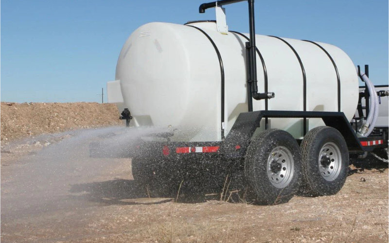 a water trailer spraying water with the rear sprayer