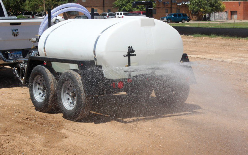a 550 gal water trailer spraying with the rear sprayer