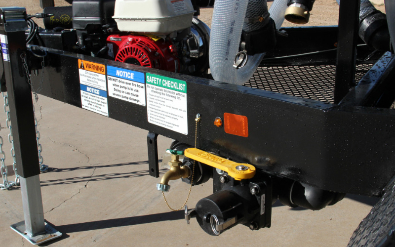 Detail view of water trailer controls, including gas-powered pump, ball valve, and suction port—built for efficient field operation.