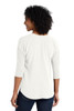 Port Authority® women’s split neck top shown from side, highlighting drop tail hem, side vent, and back seaming detail back view