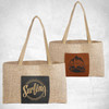Two burlap tote bags with laserable leatherette gussets and front pockets, displayed in different color combinations.