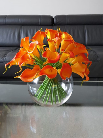 Orange Calla Lilies in Bubble Ball. Arrangement with fake water.