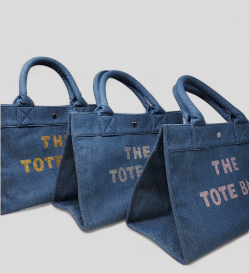 ClaraNY Denim book tote indigo denim spacious and charming  with "The Tote Bag"  letteringlder strap