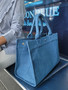 ClaraNY Denim book tote indigo denim spacious and charming  with "The Tote Bag"  letteringlder strap