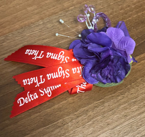 COLLEGIATE MINI African violet corsage - Delta text ribbon strips-   DESIGNS WILL VARY - clusters of African violets - Collegiate African violet corsage 