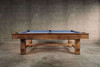 Side view of the Doc & Holliday Churchill Rustic Pool & Billiard Table in Distressed Burl Pine with Championship blue felt, photographed during the studio shoot. Distressed finish, sturdy pine frame, and custom buffalo nickel billiard sights emphasize its rustic American craftsmanship.