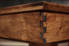 Corner joint detail of the Churchill Rustic Pool & Billiard Table in Distressed Burl Pine, with finger-jointed apron and engraved buffalo nickel billiard sight.