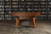 This image features the Scholar Slate Pool Table placed in an upscale residential study, surrounded by rich textures like wood paneling, a leather armchair, and soft lighting. The table’s refined silhouette and warm custom finish elevate the atmosphere, highlighting its role as both a game table and a piece of functional art. Built in the USA, it effortlessly blends style with performance.