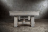 Close-up of the Churchill Pool Table leg in Smoked Maple distressed finish, rustic maple texture emphasized against a polished concrete floor backdrop.