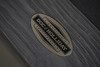 Macro shot of the Doc & Holliday name plate on the Dallas Slate Pool Table in Smoke Maple finish, photographed close-up to showcase USA-made branding, rustic pine texture, and authentic hardware detail.