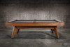 Side profile view of the Doc & Holliday Scholar Pool Table | Heritage Maple finish on solid maple hardwood with streamlined mid-century modern silhouette and tapered legs | Premium slate pool table handcrafted in the USA for contemporary living spaces