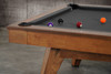 Three-quarter view of the Doc & Holliday Scholar Slate Pool Table in Heritage Maple finish | Solid maple hardwood with flared mid-century modern legs and premium slate bed | Photographed in a high-end interior setting with black felt playfield | USA-made luxury pool table by Doc & Holliday Billiards