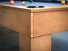 Corner close-up of Paula Parsons pool table by Doc & Holliday in glazed maple with modern Parsons edge on concrete floor