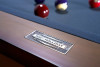 Close-up of the Doc & Holliday name plate on The Hank Slate Billiard Table in Americana Chocolate, engraved with American craftsmanship detailing on the solid maple apron.