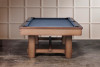 End profile view of The Hank Slate Pool Table by Doc & Holliday Billiards in Americana Chocolate, showing the Championship Titanium felt playfield along with the solid maple hardwood legs and finger-jointed apron.