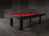 3/4 lifestyle view of the Doc & Holliday Billiards Santorini Slate Pool Table in black finish with red Championship felt styled in a modern high-end residential interior