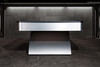 Close-up short wide profile view of the Doc & Holliday Poshy Rainbow Slate Pool Table, showcasing its brushed metallic rainbow base, matte black rails, and Euro Blue Championship felt, staged on a concrete floor with a clean modern backdrop wall.