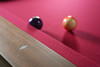 Detail shot of Santorini Slate Pool Table by Doc & Holliday Billiards highlighting walnut rails, red felt, and handcrafted leather pocket