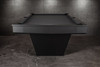 Wide-angle lifestyle view of the Doc & Holliday TRON Slate Pool Table in matte black finish | Ultra-modern industrial steel design with solid maple hardwood detailing and sleek angular base | Photographed low and wide to showcase the full silhouette, black felt playfield, and dramatic sculptural presence | USA-made luxury billiards furniture by Doc & Holliday Billiards