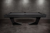 Side profile view of the Doc & Holliday TRON Slate Pool Table in matte black finish | Industrial steel frame with solid maple hardwood accents and sleek angular legs | Modern luxury pool table photographed in a high-end interior setting, highlighting the minimalist silhouette and dramatic design | USA-made contemporary billiards by Doc & Holliday Billiards