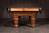 Wide profile studio shot of The Classic Slate Pool Table by Doc & Holliday. The rustic pine frame, fluted legs, and green felt surface stretch across the image, showcasing the table’s full length and handcrafted American build. This perspective emphasizes balance, proportion, and the heirloom presence of the design.