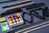 3/4 overhead view of the Doc & Holliday Luxury Billiards Kit displayed on a pool table with Championship felt. Includes polished billiard ball set, maple two-piece cue sticks, racks, chalk, and all essential accessories, arranged neatly to showcase a complete high-end game room setup.