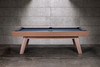 Side view of the George Pool Table highlighting the clean Gray Walnut finish and long, refined silhouette. The angled mid-century modern legs and enclosed leather drop pockets emphasize craftsmanship and style, making this slate pool table a designer centerpiece.