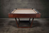 American-made Doc & Holliday Zoey in short wide profile; level stance, precise rail geometry, and maple grain texture read clearly—professional playfield presence in a modern lifestyle scene.