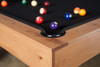 Close-up corner view of the Doc & Holliday Parsons Pool Table in Rustic White Oak. Genuine leather pocket detail with Championship black felt and the Doc & Holliday Luxury Billiard Ball Set displayed on the playfield. Handcrafted in the USA from solid white oak.