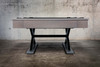 Side profile of The Metalsmith pool table by Doc & Holliday with black felt and steel X-legs.
