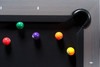 Overhead corner perspective of The Metalsmith by Doc & Holliday, showing black Championship felt, polished slate edges, and the seamless integration of metal and wood materials. Designed as both a gaming surface and centerpiece of modern interiors.