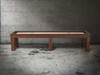 Side view of 12-foot Paula Parsons Shuffleboard Table by Doc & Holliday in Grey Walnut, captured on concrete floor to showcase its bold Parsons-style frame, streamlined silhouette, and maple butcher block playfield.