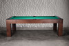 Luxury pool table in natural walnut finish by Doc & Holliday, captured at a three-quarter angle against a modern industrial-inspired studio background for a high-end lifestyle presentation.