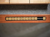 Close-up of the recessed scoring system on the Natural Walnut Paula Parsons Shuffleboard Table by Doc & Holliday, featuring brass numeric tiles set into the walnut rail.
